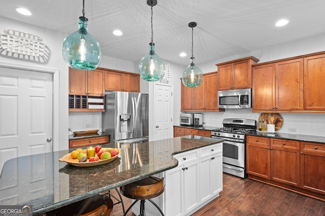 kitchen featuring recessed lighting, brown cabinets, appliances with stainless steel finishes, and decorative light fixtures