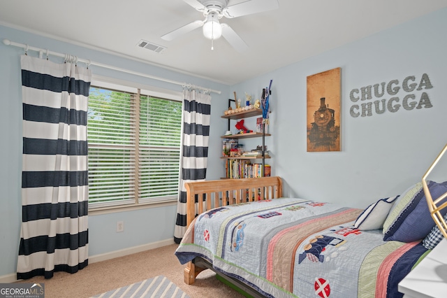 bedroom with baseboards, carpet flooring, visible vents, and a ceiling fan