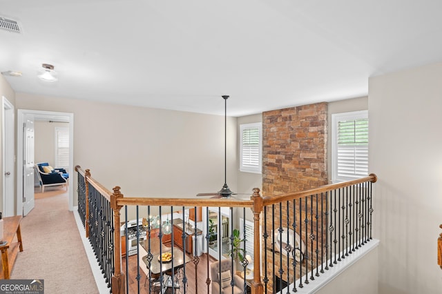 corridor featuring visible vents and an upstairs landing