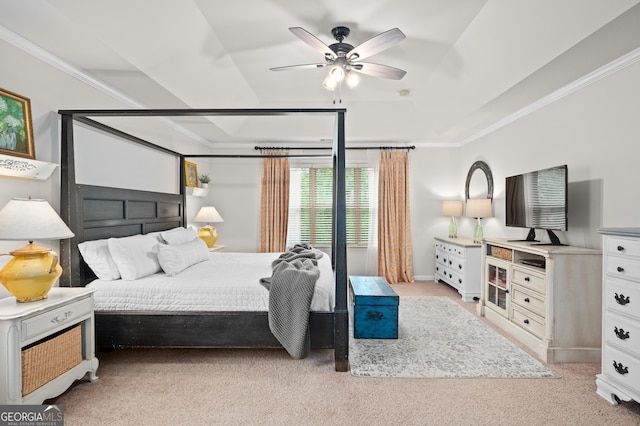 bedroom with baseboards, a raised ceiling, ceiling fan, light colored carpet, and ornamental molding