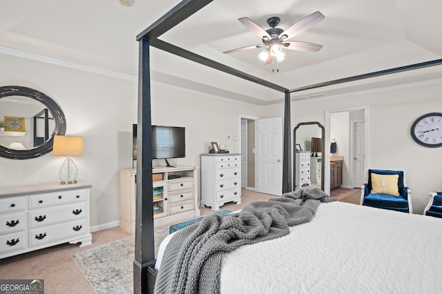 bedroom with ensuite bathroom, a raised ceiling, ceiling fan, light carpet, and ornamental molding
