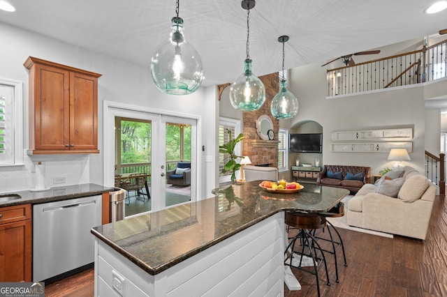 kitchen featuring brown cabinets, dark wood-type flooring, open floor plan, and dishwasher
