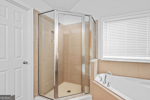 full bath with a garden tub and a stall shower