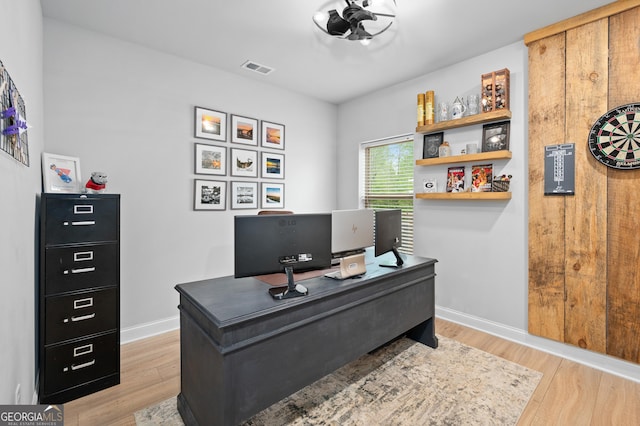 office featuring baseboards, visible vents, and light wood-type flooring