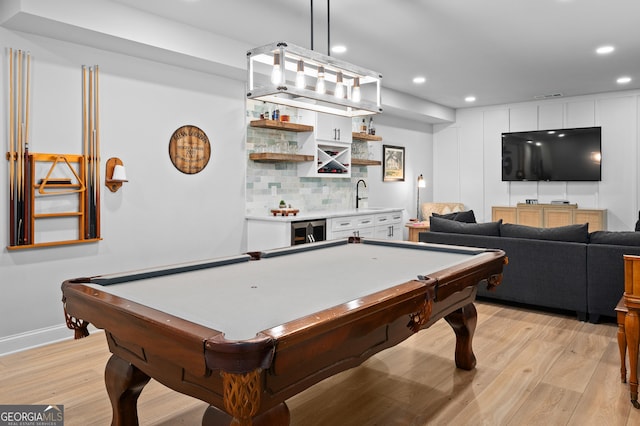 recreation room featuring light wood-style flooring, indoor wet bar, and recessed lighting