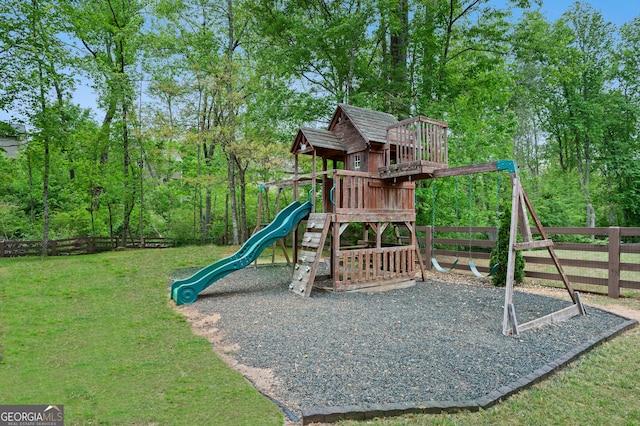 view of jungle gym featuring fence and a lawn