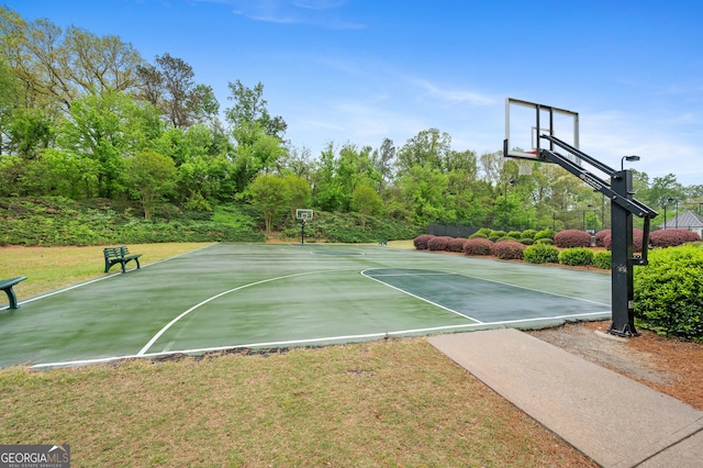 view of basketball court with a lawn and community basketball court