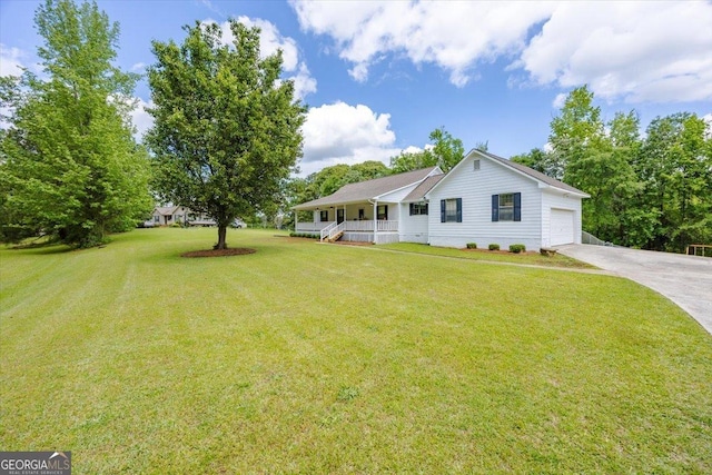 view of front facade featuring a garage, covered porch, concrete driveway, and a front lawn