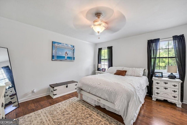 bedroom featuring ceiling fan, baseboards, ornamental molding, and wood finished floors