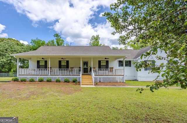 single story home with covered porch, a ceiling fan, a shingled roof, and a front lawn