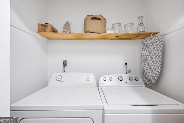 clothes washing area featuring laundry area and washer and clothes dryer
