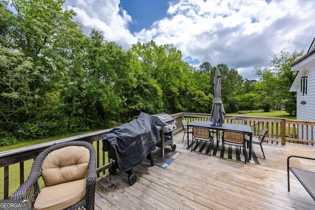 wooden terrace featuring outdoor dining space