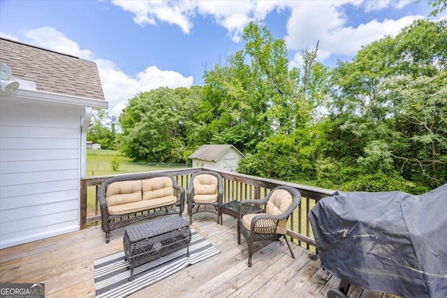 wooden terrace with a storage unit, an outbuilding, and outdoor lounge area