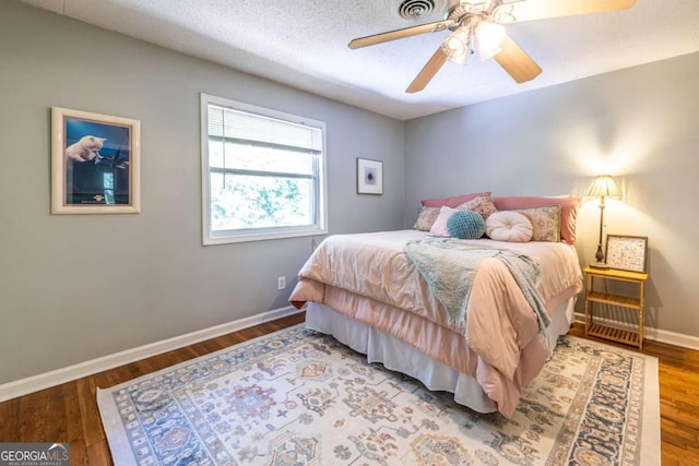 520 Park Ave SE Unit 10, Atlanta, GA 30312 - bedroom with a textured ceiling, a ceiling fan, baseboards, wood finished floors, and visible vents