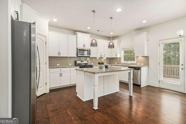 308 Evening Rain Crst, Canton, GA 30114 - kitchen with stainless steel appliances, decorative backsplash, white cabinets, a center island, and a kitchen breakfast bar
