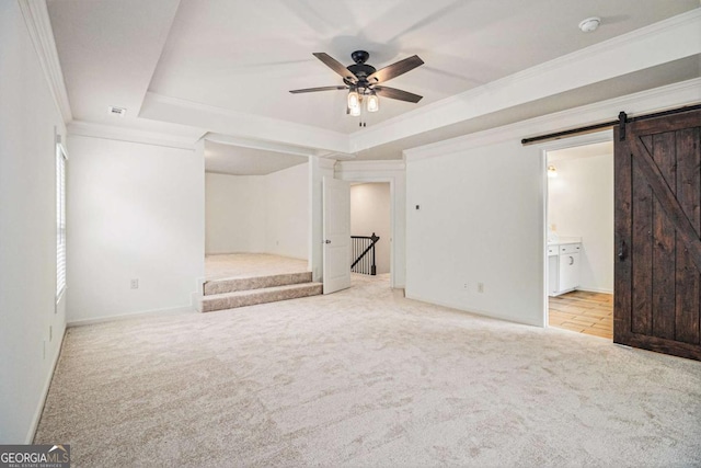 308 Evening Rain Crst, Canton, GA 30114 - unfurnished bedroom with carpet floors, a raised ceiling, a barn door, crown molding, and ensuite bathroom