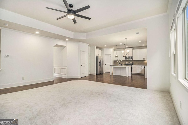 308 Evening Rain Crst, Canton, GA 30114 - unfurnished living room featuring recessed lighting, a ceiling fan, ornamental molding, dark carpet, and a chandelier