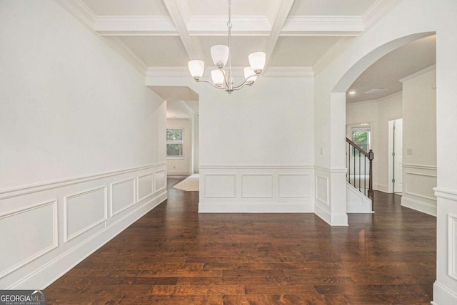 308 Evening Rain Crst, Canton, GA 30114 - unfurnished dining area featuring arched walkways, a chandelier, coffered ceiling, beamed ceiling, and a decorative wall