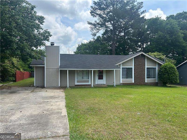 8922 Gatewood Cir, Jonesboro, GA 30238 - single story home with covered porch, a chimney, fence, a front lawn, and concrete driveway