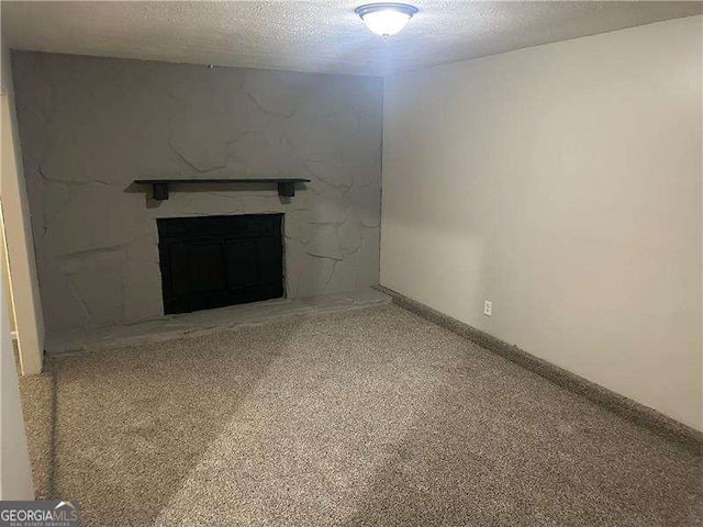 8922 Gatewood Cir, Jonesboro, GA 30238 - unfurnished living room featuring a textured ceiling, light carpet, and a stone fireplace