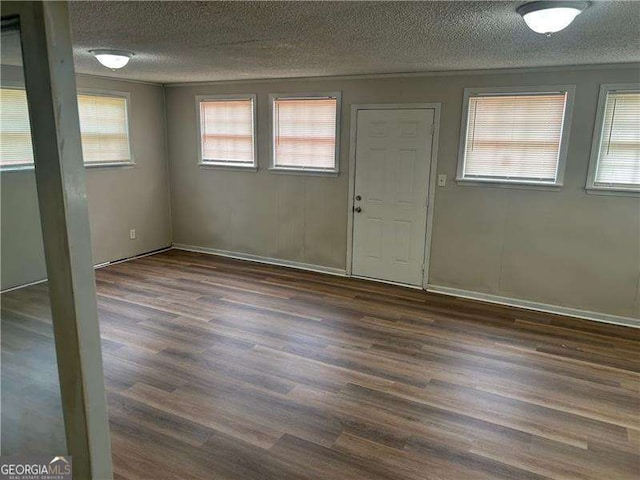 8922 Gatewood Cir, Jonesboro, GA 30238 - entryway with dark wood-type flooring, a textured ceiling, and a healthy amount of sunlight