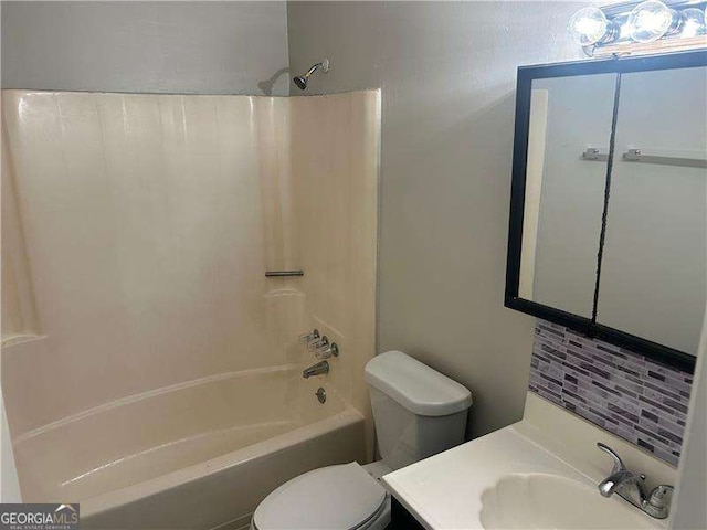 8922 Gatewood Cir, Jonesboro, GA 30238 - full bathroom featuring backsplash, toilet, shower / tub combination, and vanity