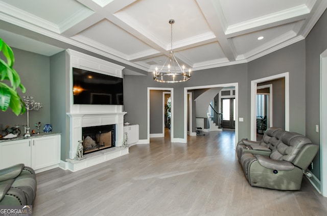 unfurnished living room featuring an inviting chandelier, beam ceiling, stairway, and coffered ceiling
