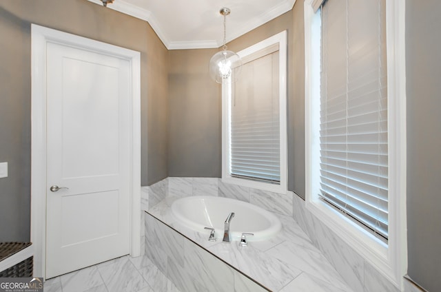 bathroom with crown molding, marble finish floor, and a garden tub