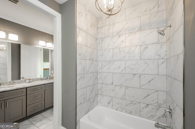 bathroom with double vanity, marble finish floor, shower / bathing tub combination, a chandelier, and a sink