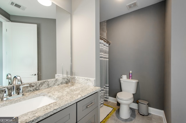 bathroom featuring visible vents, baseboards, toilet, and vanity