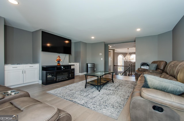 living area featuring recessed lighting, wood finished floors, and a chandelier