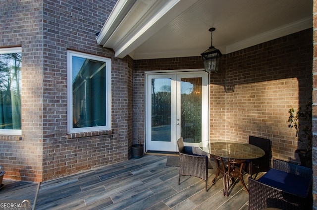 deck with french doors and outdoor dining space