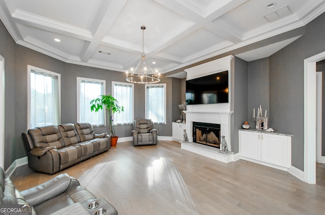 living room featuring a fireplace, beamed ceiling, light wood-style flooring, and a notable chandelier