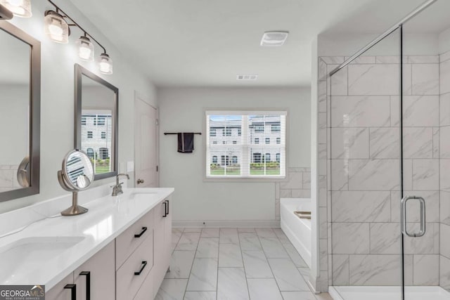 3493 Monarch Ave, Duluth, GA 30096 - full bathroom with a sink, marble finish floor, visible vents, a garden tub, and a stall shower