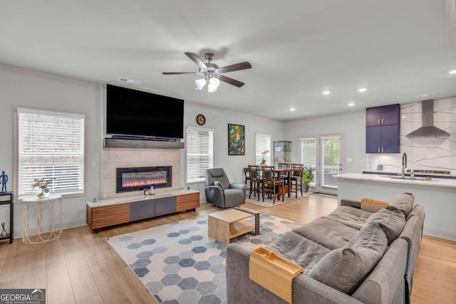 3493 Monarch Ave, Duluth, GA 30096 - living area featuring recessed lighting, a ceiling fan, light wood-style floors, and a tile fireplace