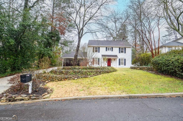 colonial home with a front lawn
