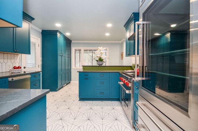 kitchen featuring a peninsula, dark stone counters, ornamental molding, stainless steel appliances, and recessed lighting