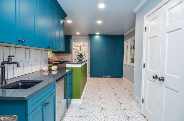 kitchen featuring recessed lighting, a sink, decorative backsplash, and ornamental molding