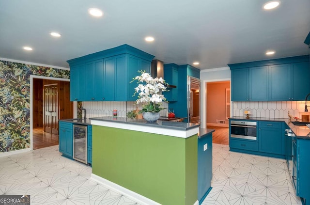 kitchen featuring wine cooler, crown molding, stainless steel oven, and recessed lighting