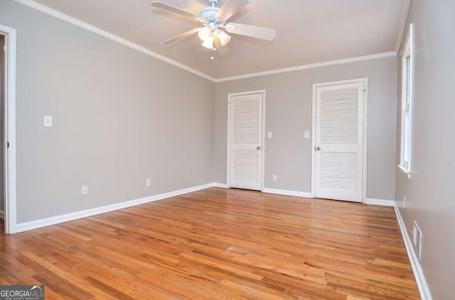 interior space featuring crown molding, baseboards, a ceiling fan, and light wood-style flooring