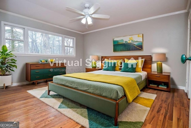 bedroom featuring crown molding, baseboards, and wood finished floors