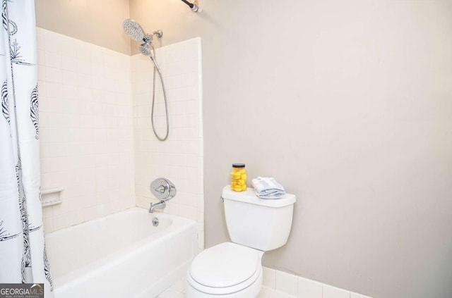 full bath with toilet and shower / bath combo with shower curtain