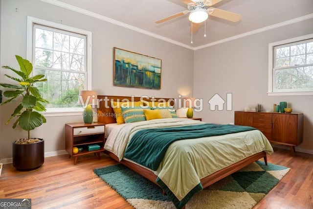 bedroom with a ceiling fan, baseboards, ornamental molding, and light wood-style floors
