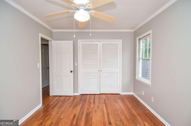 unfurnished bedroom featuring baseboards, ornamental molding, and light wood-style flooring