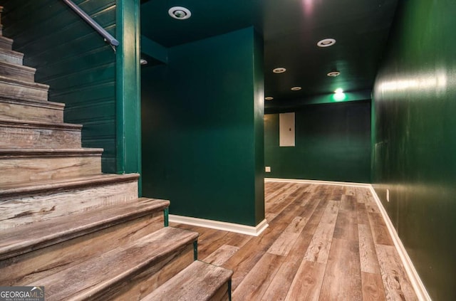 stairway featuring baseboards, recessed lighting, and wood finished floors