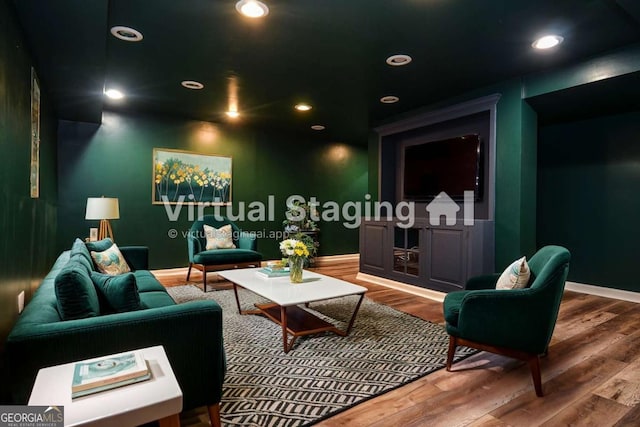 living area with baseboards, recessed lighting, and wood finished floors