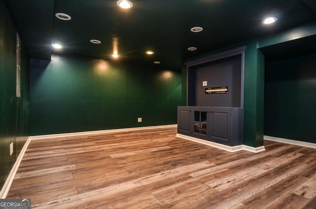 unfurnished room with baseboards, recessed lighting, and wood finished floors