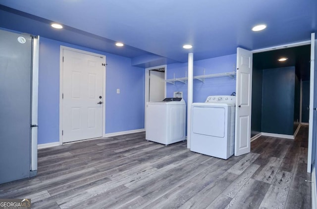 washroom with baseboards, recessed lighting, wood finished floors, and washer and clothes dryer