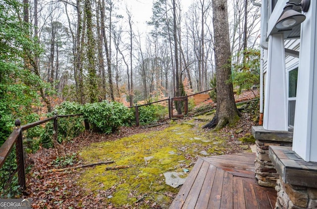 view of yard with fence and a deck