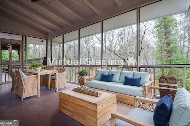 sunroom with outdoor dining area, a wealth of natural light, beam ceiling, and an outdoor hangout area